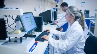 Lab technician working at a computer
